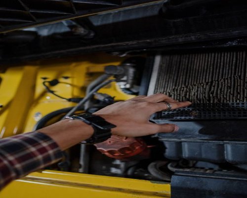 air conditioner filter being checked during routine maintenance
