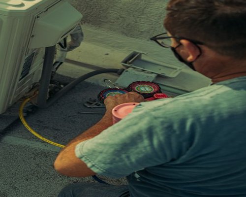 AC service technician preparing tools for a maintenance visit